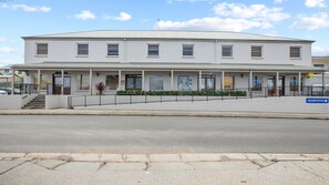 A two-story building with a flat roof, multiple windows, and a covered entrance area with a sign for 'Advanced Dental'. - 8 on Clarence - perfectly located in the centre of town (Moss Vale)