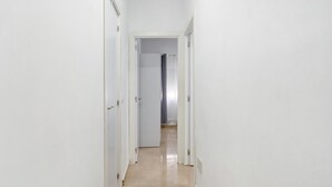 A narrow hallway with white walls and a tiled floor, leading to a room with a shower. - Holiday Apartment "Un Descanso 1" in City Center with Wi-Fi (San Fernando)