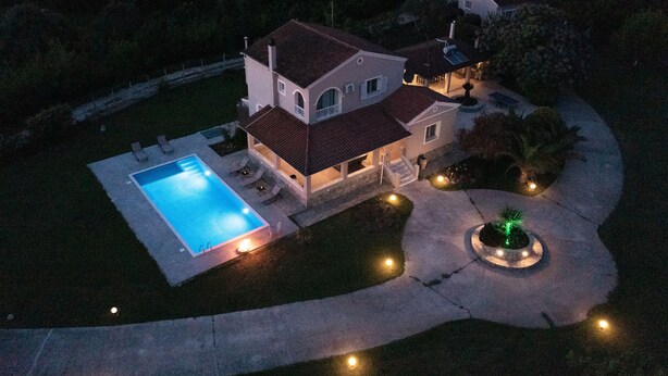 A two-story house with a swimming pool, a covered patio, and a landscaped garden. - Country Villa Verde (Corfu)
