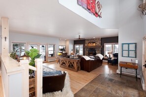Cozy living area with a stone fireplace, comfortable sofa, and plush rug.