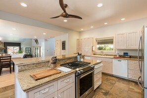 Enjoy cooking in this well-lit kitchen with a central island, stove, and oven.