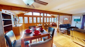 A cozy cabin with a dining area, a living room, and a kitchen. - 3 bedroom, 1 bath elevated home with private pool, walking distance to beach! (Isle of Palms)
