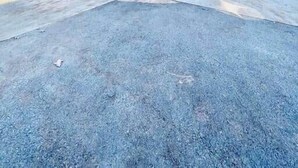 Une cabane en rondins avec un toit à forte pente, une cheminée et un garage.