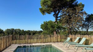 A rectangular pool with clear blue water, surrounded by a tiled deck. There are lounge chairs along the poolside. - Château Tournefeuille in the heart of the vineyards! (Néac)