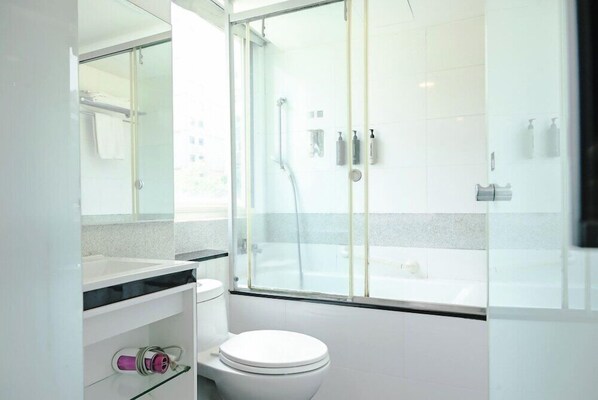 A modern bathroom with a glass shower enclosure, a white toilet, and a vanity with a mirror. - Check inn Express Taipei Yongkang (Taipei)