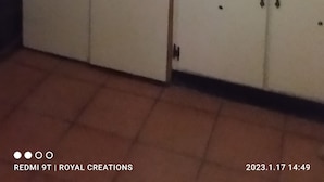 A kitchen with a countertop, cabinets, and a sink.