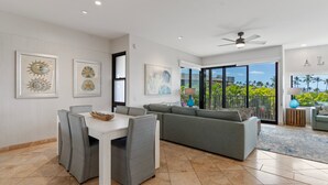 A modern living room with a dining area, large windows, and artwork on the walls. - Wailea Elua, #0801 2 Bedroom Condo by RedAwning (Kihei)