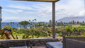 A covered outdoor seating area with a view of the ocean and mountains. - Wailea Elua, #2003 1 Bedroom Condo by RedAwning (Kihei)