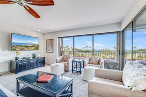 A spacious living room with a large window offering a view of the beach and ocean. - Wailea Elua, #0105 2 Bedroom Condo by RedAwning (Kihei)