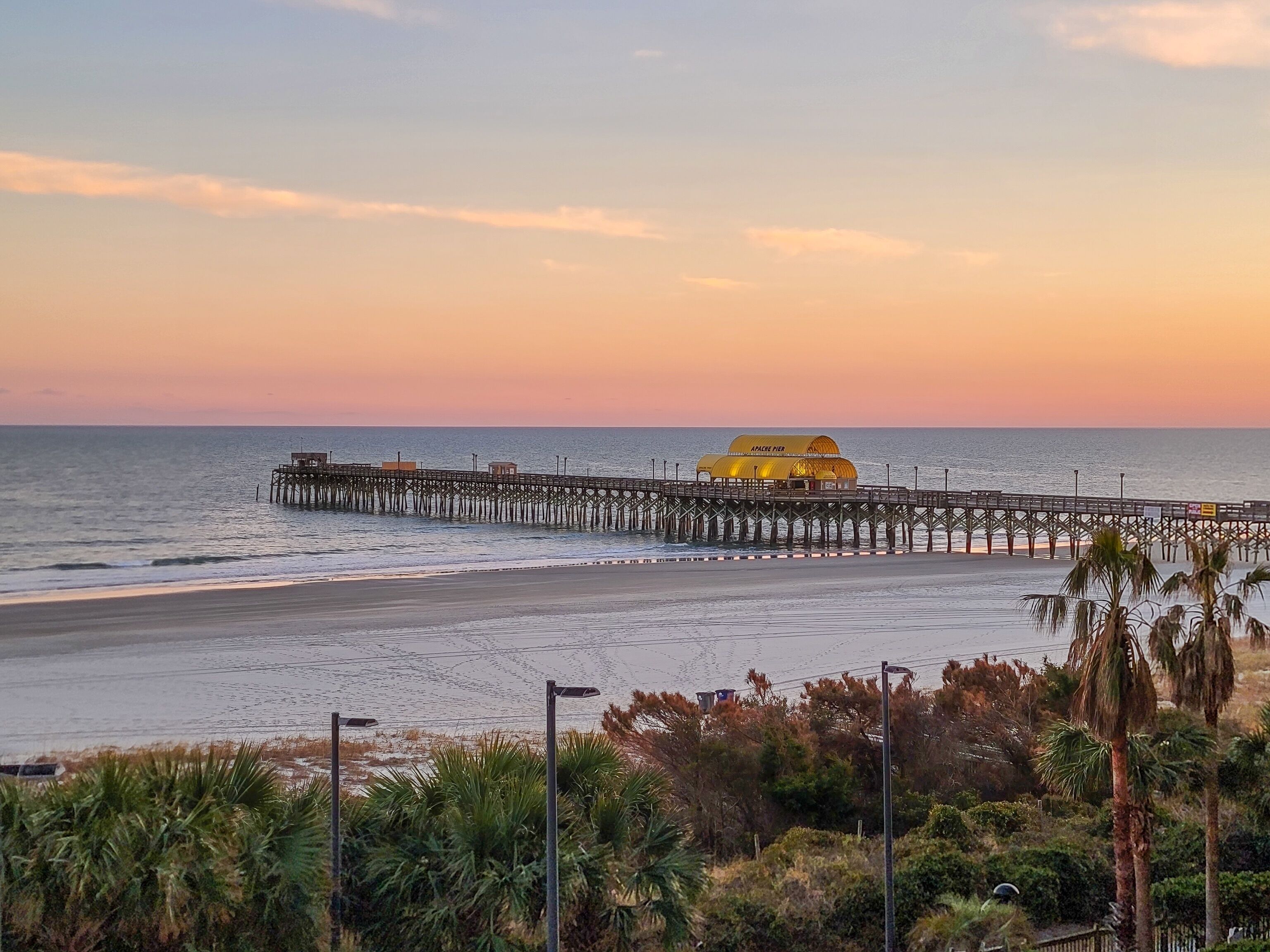 A pier extending into the water with a building labeled "APACHE PIER" at the end.