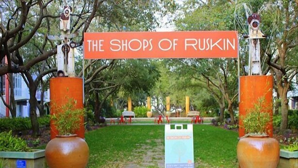 A sign reading "The Shops of Ruskin" with a pathway leading through a park-like setting. - Seaside "Happy Our" | 6BR |Sleeps 18 | 4 Bikes | Pools (Santa Rosa Beach)