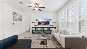 A modern living room with a sofa, coffee table, and TV.