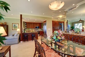 A modern kitchen with wooden cabinets, stainless steel appliances, and a marble countertop. - Wailea Elua, #1403 2 Bedroom Condo by RedAwning (Kihei)