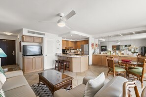 A modern kitchen with a central island, wooden cabinets, and stainless steel appliances. - Kihei Beach, #603^ 1 Bedroom Condo by RedAwning (Kihei)