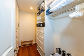 A walk-in closet with multiple drawers, shelves, and a built-in heater. - Wailea Elua, #0305 2 Bedroom Condo by RedAwning (Kihei)
