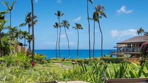 A tropical resort with a view of the ocean, palm trees, and a well-maintained garden. - Wailea Elua, #1601 1 Bedroom Condo by RedAwning (Kihei)