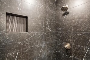 A bathroom with dark marble tiles, a circular sink, and a showerhead. - Wailea Elua, #1601 1 Bedroom Condo by RedAwning (Kihei)