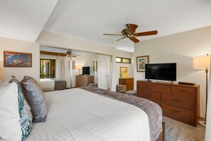A bedroom with a large bed, a ceiling fan, a TV, and a dresser. - Wailea Elua, #1601 1 Bedroom Condo by RedAwning (Kihei)