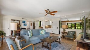 A spacious living room with a grey sofa, wooden coffee table, and a ceiling fan. - Wailea Elua, #1601 1 Bedroom Condo by RedAwning (Kihei)