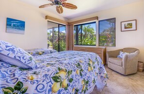 A bedroom with a bed, a chair, a ceiling fan, and a window with blinds. - Wailea Elua, #2201^ 2 Bedroom Condo by RedAwning (Kihei)