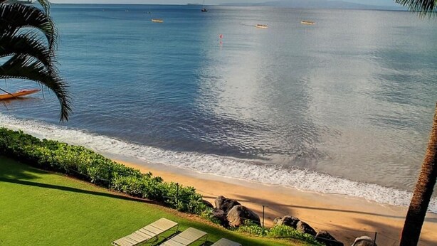 A beach view with a clear sky, calm sea, and a few boats. - Kihei Beach, #307 1 Bedroom Condo by RedAwning (Kihei)