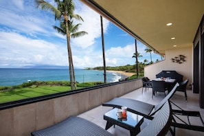 A balcony with a view of the ocean, a grill, and outdoor seating. - Makena Surf, #f-209 2 Bedroom Condo by RedAwning (Kihei)