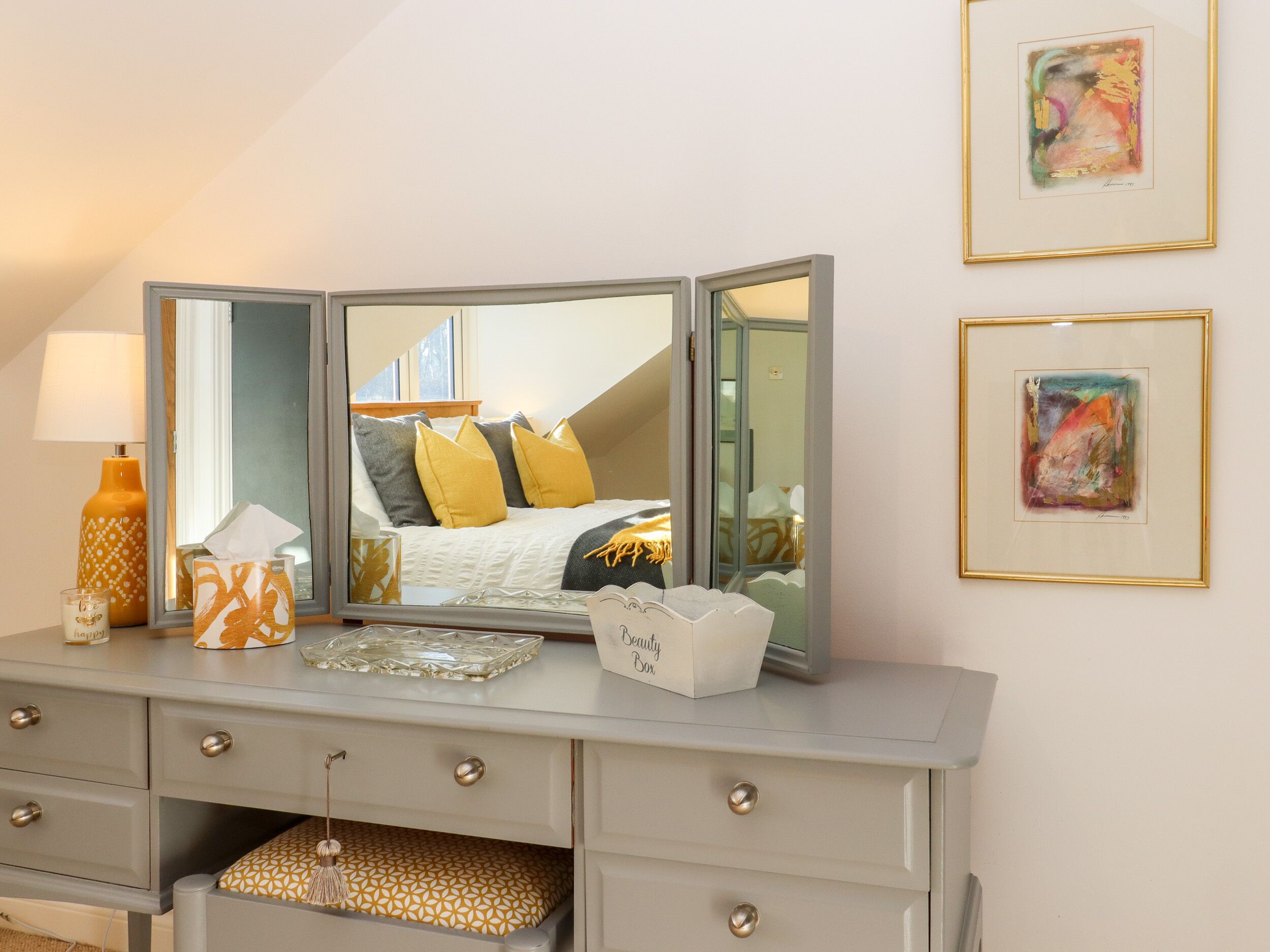 A bedroom with a bed, bedside table, and a dresser with drawers.