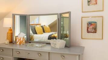 A bedroom with a bed, bedside table, and a dresser with drawers.