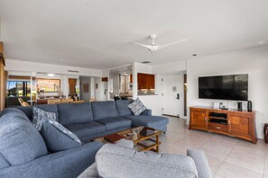 A modern living room with a large sofa, a coffee table, and a television. - Wailea Elua, #1503 2 Bedroom Condo by RedAwning (Kihei)