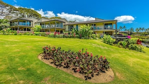 A modern hotel with multiple two-story buildings, a well-maintained lawn, and tropical landscaping. - Wailea Elua, #1305^ 3 Bedroom Condo by RedAwning (Kihei)