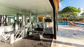 A gym with exercise equipment and a pool area with lounge chairs. - Wailea Elua, #1305^ 3 Bedroom Condo by RedAwning (Kihei)