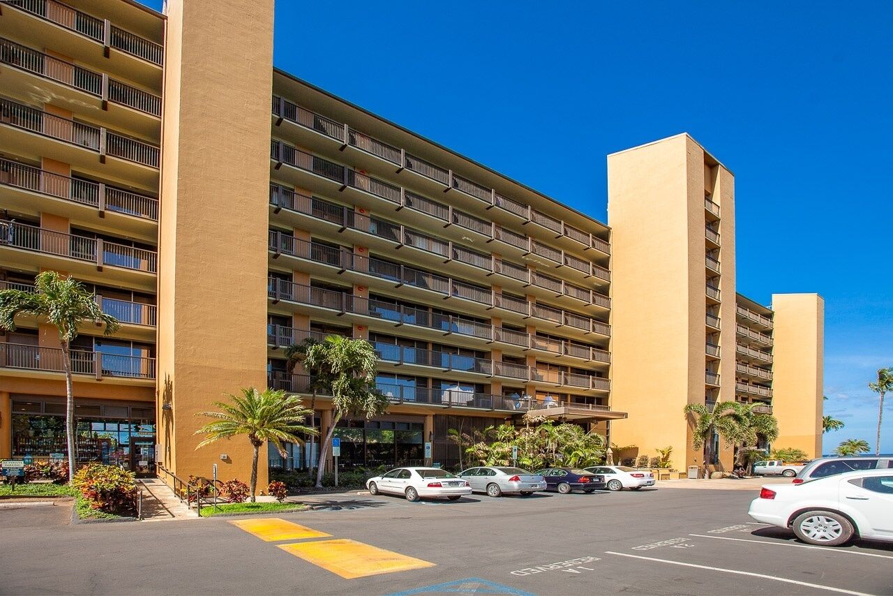 A multi-story hotel with a uniform exterior, featuring balconies on each floor.