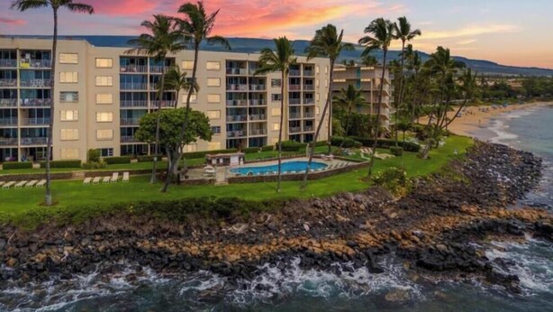 A hotel with multiple floors, a pool, and a view of the ocean. - Royal Mauian, #205 2 Bedroom Condo by RedAwning (Kihei)