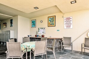 A hotel lobby with a reception desk, chairs, a clock, and artwork on the walls. - Big Island Kona Magic Sands by Coldwell Banker Island Vacations (Kailua-Kona)