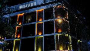 A hotel with a modern facade, large windows, and a reception area. - Punta Vista Otel (Izmir)