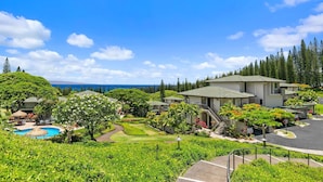 A resort with multiple buildings, a swimming pool, and lush greenery. - Kapalua Golf Villas by Coldwell Banker Island Vacations (Lahaina)