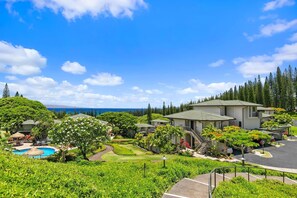 A resort with multiple buildings, a swimming pool, and lush greenery. - Kapalua Golf Villas by Coldwell Banker Island Vacations (Lahaina)