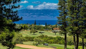 A golf course with a view of the ocean and mountains in the background. - Kapalua Golf Villas by Coldwell Banker Island Vacations (Lahaina)