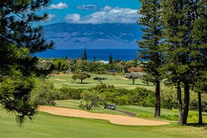 A golf course with a view of the ocean and mountains in the background. - Kapalua Golf Villas by Coldwell Banker Island Vacations (Lahaina)