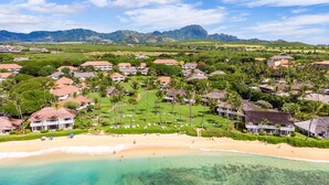A resort with beachfront villas, a golf course, and a beach. - Kauai Kiahuna Plantation by Coldwell Banker Island Vacations (Koloa)