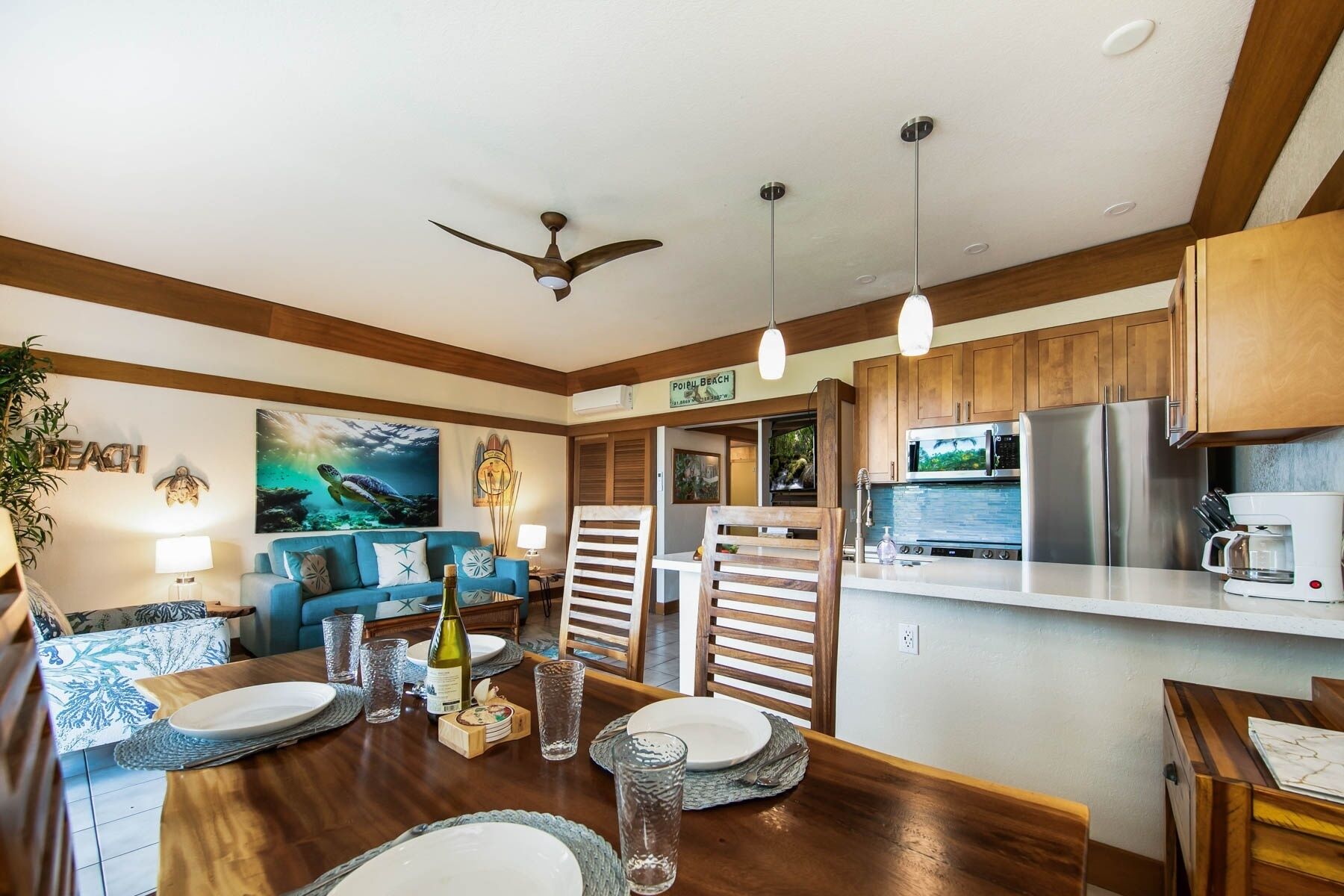 A modern kitchen with wooden cabinets, a stainless steel refrigerator, and a microwave.