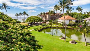 A resort with a pool, palm trees, and a view of the ocean. - Kauai Kiahuna Plantation by Coldwell Banker Island Vacations (Koloa)