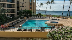 A hotel pool area with multiple lounge chairs and a large pool. - Sugar Beach Resort, #329 1 Bedroom Condo by RedAwning (Kihei)