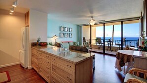 A spacious living area with a kitchen, dining area, and a balcony with a view of the ocean. - Sugar Beach Resort, #329 1 Bedroom Condo by RedAwning (Kihei)