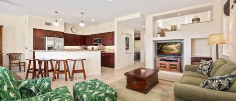 A spacious living area with a kitchen, a dining set, and a comfortable seating area.