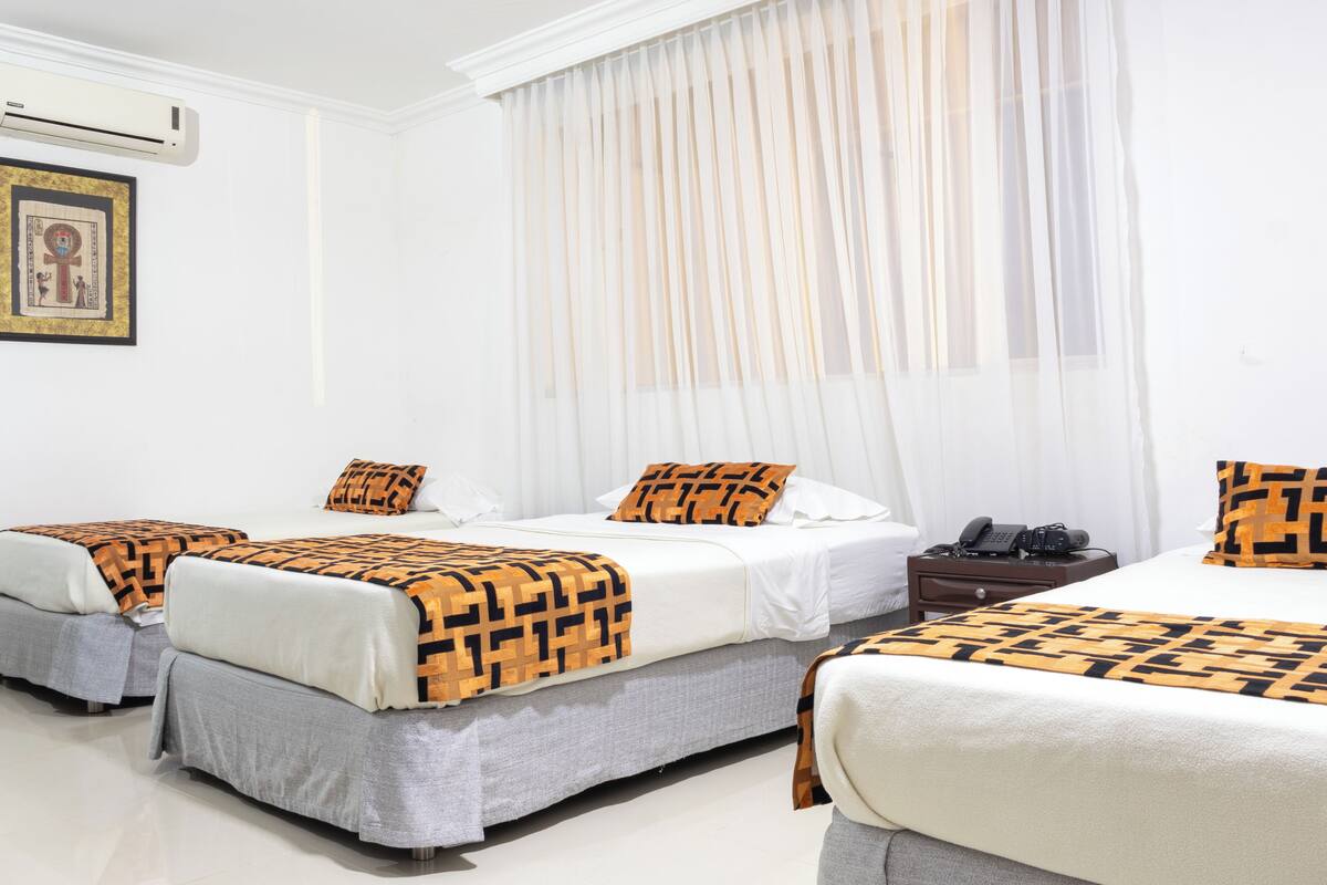 Standard Triple Room | Desk, laptop workspace, blackout curtains, iron/ironing board