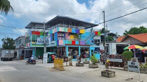 Un edificio colorido con una farmacia y una cafetería.