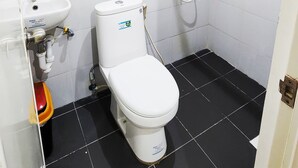 Un baño pequeño y limpio con inodoro, bidé y lavamanos.