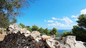 A stone structure with a view of the sea and trees. - Florio house 300 (Santa Maria di Leuca)
