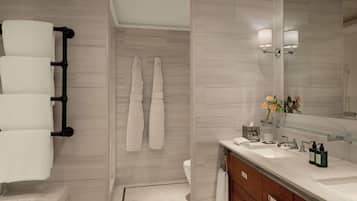 A modern bathroom with a bathtub, a vanity with a mirror, and a shower area.